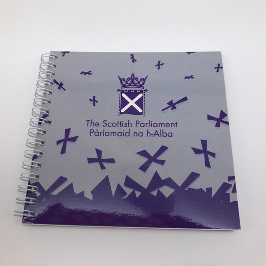 Spiral bound, square notebook with purple Parliament symbol and saltires on grey background.