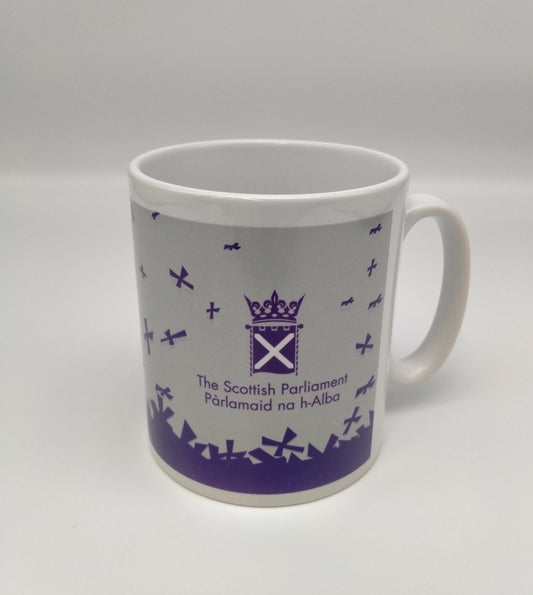 White mug printed with with purple Parliament symbol and saltires on grey background.