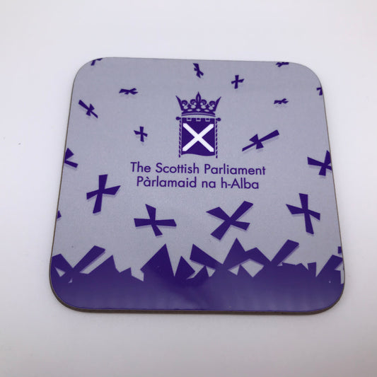 A square coaster with the symbol of the Scottish Parlaiment and purple saltires on grey background.