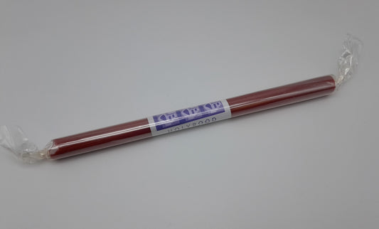 A red stick of rock in a plastic wrapping with a white and blue label.