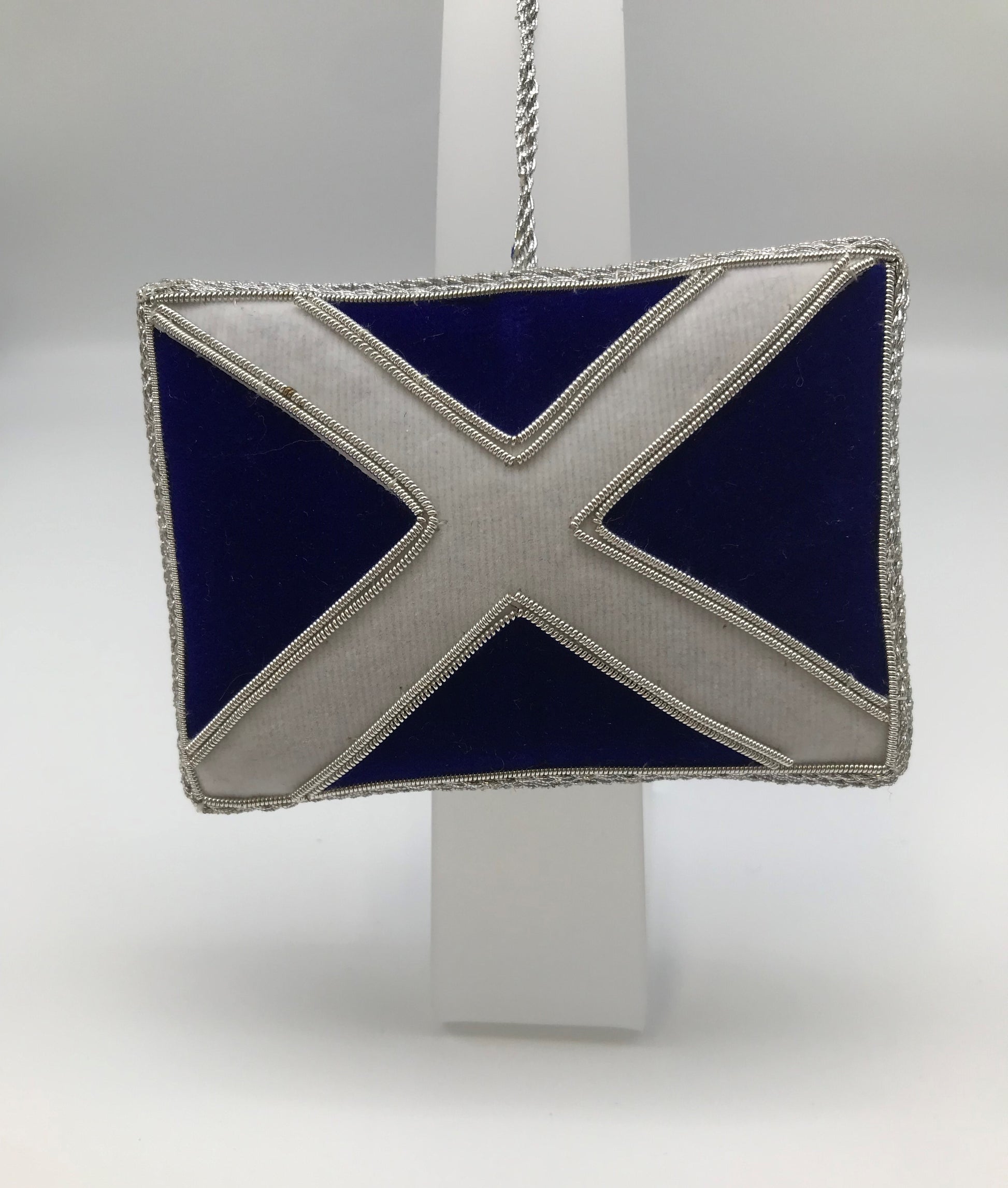 Other side of the decoration showing Scottish flag - white St Andrew's cross over blue fabric with decorative silver stitching.