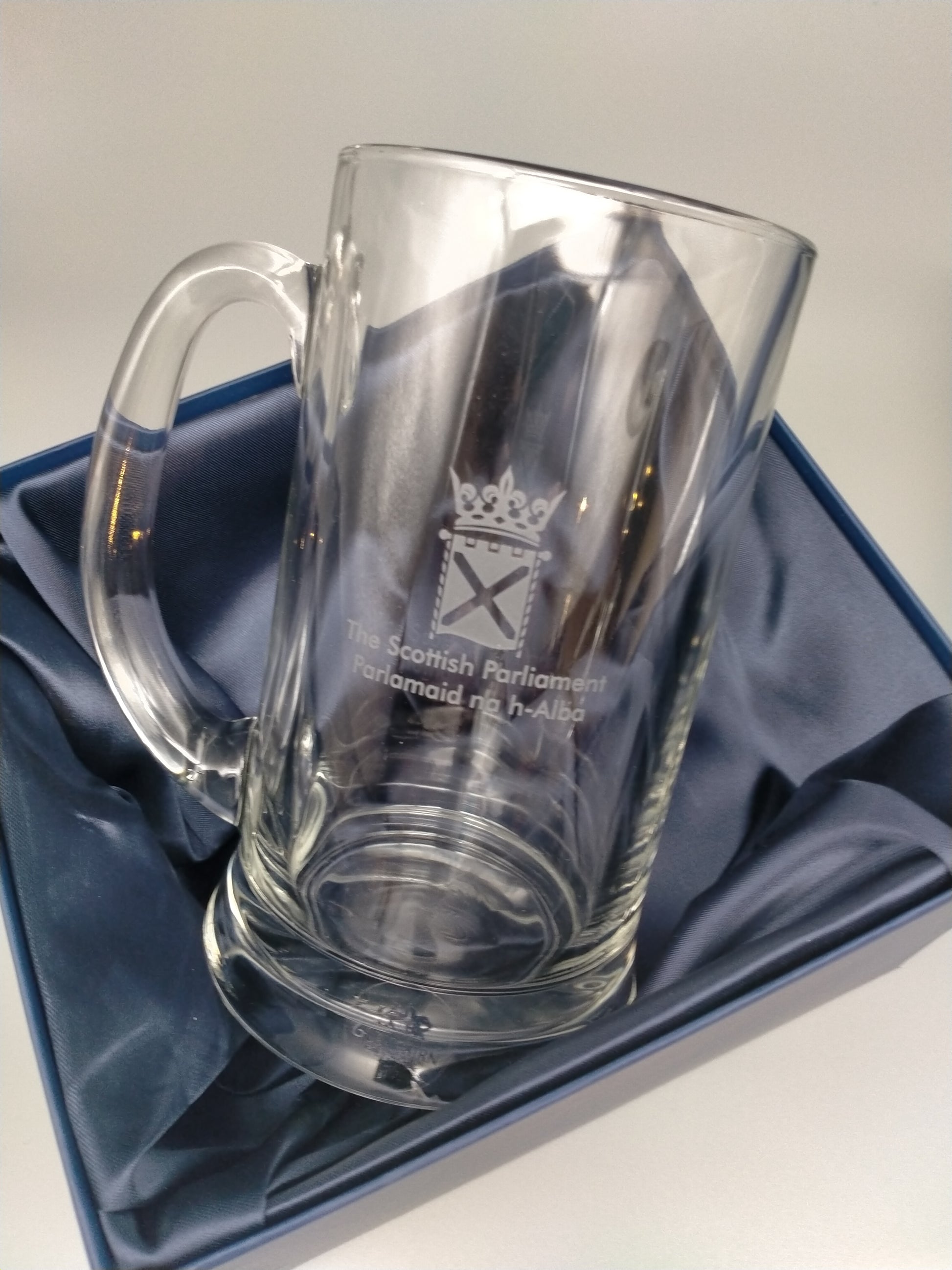 The tankard in its box lined with navy blue fabric.
