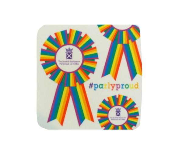 Square white coaster with multi-coloured rosettes printed on surface. The centre of each rosette features the symbol of the Parliament. Text reads #Parlyproud