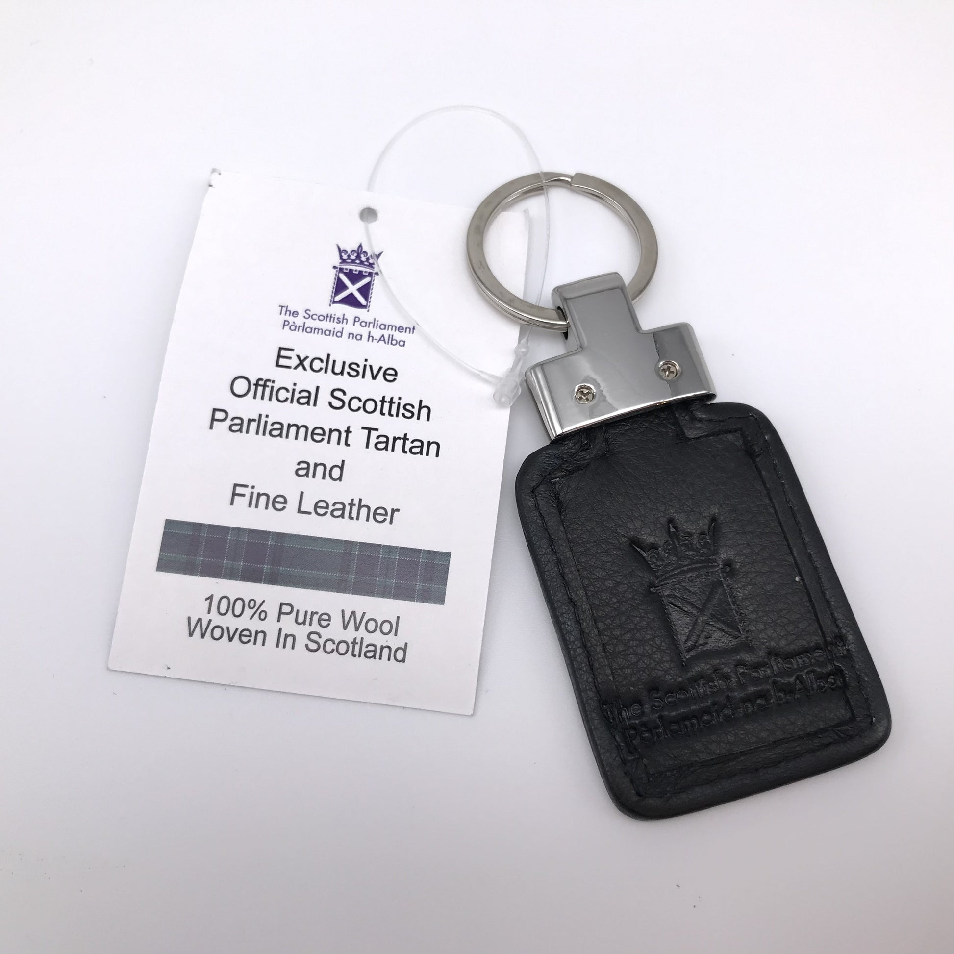 Black leather reverse of key fob. Embossed with symbol of Parliament. Silver coloured fittings.  Tag attached.