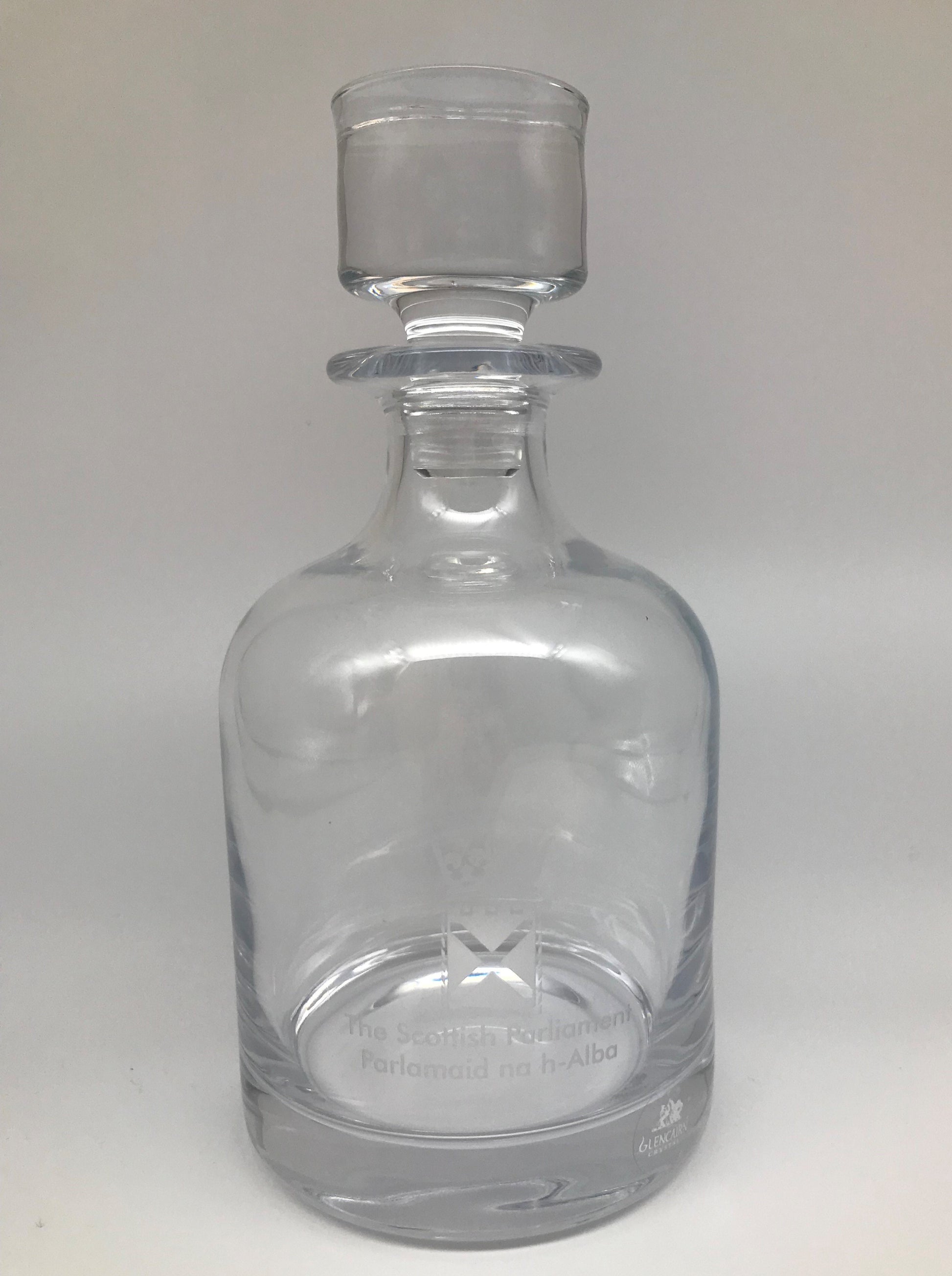 Glass decanter with an engraved symbol of the Scottish Parliament.