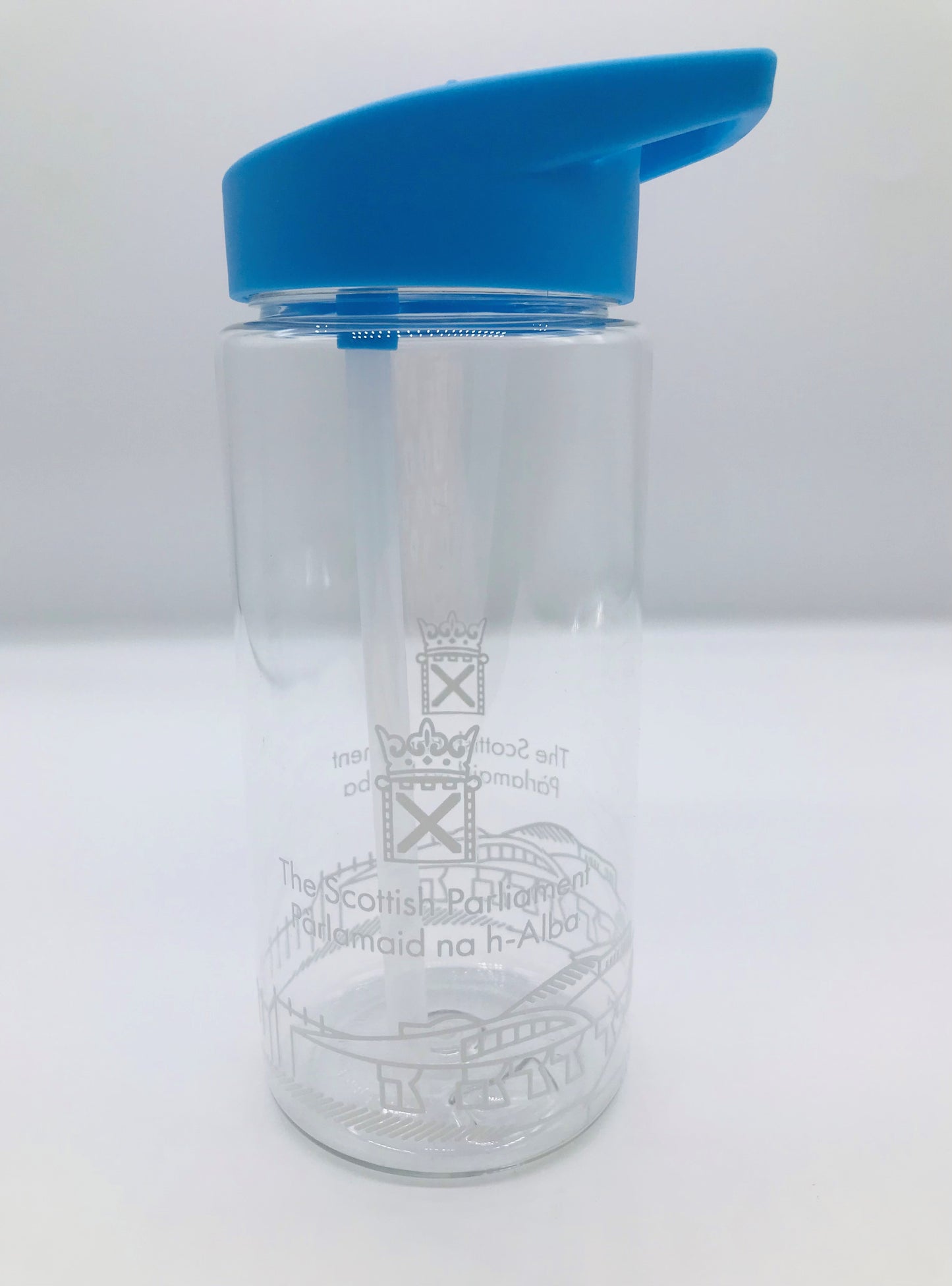 A clear plastic bottle with internal straw. it has the Scottish Parliament logo and outline of the parliament building painted around the circumference of the bottle. Its lid is blue