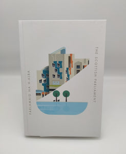 White hardback notebook printed with an image of a part of the Scottish Parliament building. A contemporary design features some architectural details of the building, a pond and trees. Writing The Scottish Parlaiment in English and Gaelic.