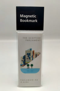 A white magnetic bookmark printed with an image of a part of the Scottish Parliament building. A contemporary design features some architectural details of the building, a pond and trees. Writing The Scottish Parlaiment in English and Gaelic.