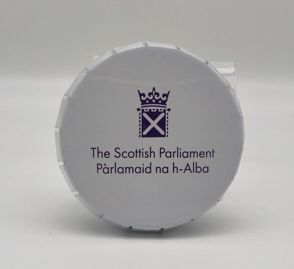 A small round white tin with the Parliament symbol printed on the lid in purple.