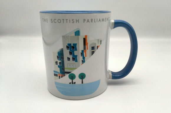 A white mug printed with an image of a part of the Scottish Parliament building. A contemporary design features some architectural details of the building, a pond and trees. Writing The Scottish Parlaiment in English. Blue handle.