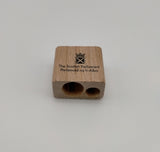 Sharpener with two holes of different size, decorated with the symbol of the Scottish Parliament. 