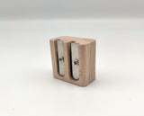 Square, wooden pencil sharpener.
