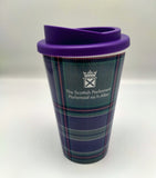 A reusable cup printed with the Scottish Parliament tartan with a purple ild. Decorated with the symbol of the Scottish Parliament.