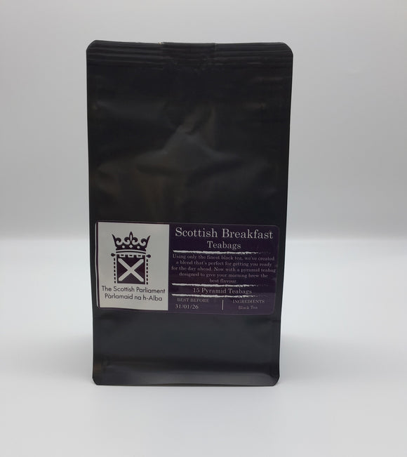 A black bag with the label: Scottish Brekfast Tea and the symbol of the Scottish Parliament.