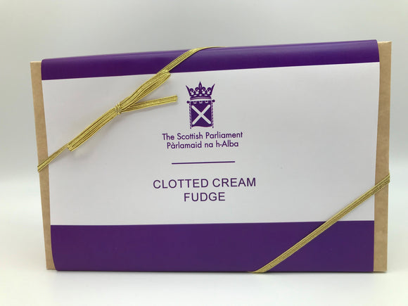 A rectangular box with white and purple label and golden ribbon. 