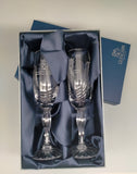 The pair of crystal flute glasses in blue presentation box  which is lined with navy blue fabric.