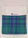 A folded tea towel printed in the Scottish Parliament tartan.