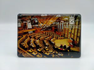 Rectangular magnet showing an image of the exterior of the Parliament building and the Parliament symbol.