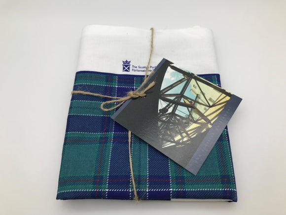 tartan tea towel, folded and tied with a string.