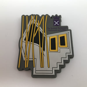 MSP window shaped magnet. shades of grey with gold highlights. Purple symbol of Parliament.