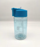 Transparent bottle tinted blue and decorated with the symbol of the Scottish Parliament. Lid is blue with a transparent pop-up spout.