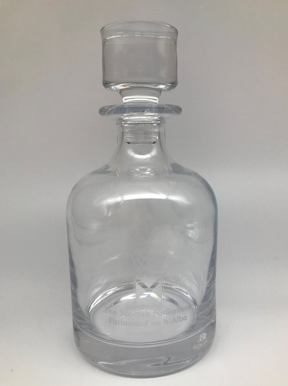 Glass decanter with an engraved symbol of the Scottish Parliament.