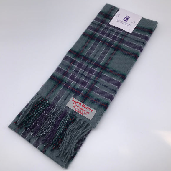 A woollen scarf in the Scottish Parliament tartan, showing the label with the name of the maker and care instructions: 'Ingles Buchan, 100% lambswool, made in Scotland, dry clean'.