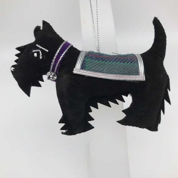 Standing black dog with tartan coat. Purple collar and silver stitching detail.