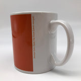 The mug photographed from the back, showing the handle and the vertical writing in small print: Excerpt from Open the Doors Edwin Morgan.