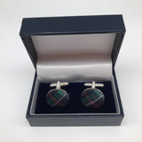 The cufflinks in their black box with white lining.