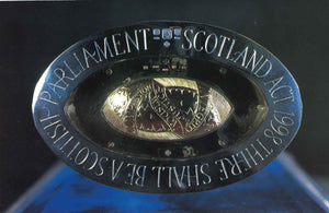 The front of the card featuring the head of the mace with engraved words: Scotland Act 1998 There Shall be a Scottish Parliament.