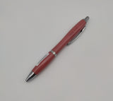 Red pen decorated with the symbol of the Scottish Parliament with silver elements.