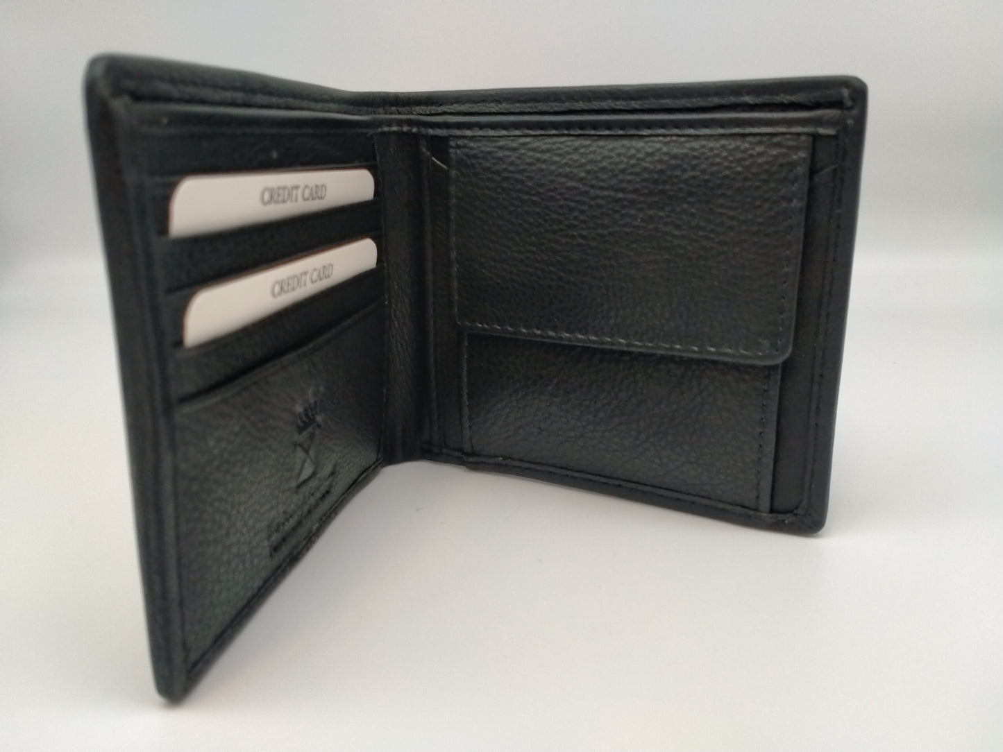 Wallet standing upright. Open showing black leather interior with compartments for notes and cards and coin purse.